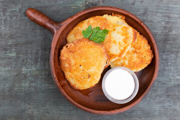 Fried grated potato pancakes with sour cream