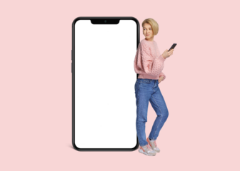 Full body side view young woman wear pink casual sweater lean on blank isolated PNG screen mobile cell phone with area use smartphone isolated on plain pastel light background.