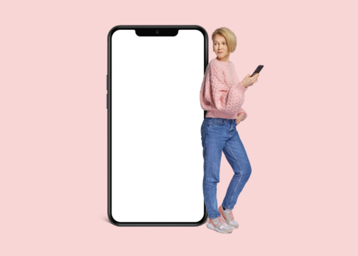 Full body side view young woman wear pink casual sweater lean on blank isolated PNG screen mobile cell phone with area use smartphone isolated on plain pastel light background.