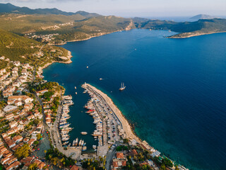 Aerial drone shot of Kaş center and marina, highlighting the vibrant coastal landscape, turquoise waters, and Mediterranean architecture in Antalya, Turkey.