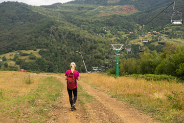 Fototapeta na wymiar Fit woman walking on the mountain. Healthy lifestyle concept