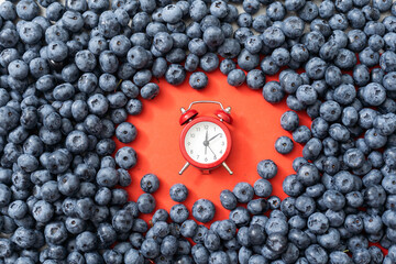 Time for seasonal berries and vitamins for a snack, breakfast, clock