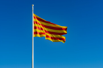 Catalonia's Flag Fluttering Against a Blue Sky