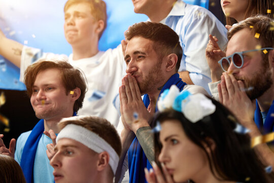 Support. Sport football fans watching greece soccer match, emotionally cheering team at stadium during game. Concept of sport, competition, championship, emotions, hobby and entertainment