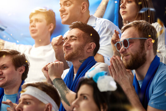 Support. Sport football fans watching greece soccer match, emotionally cheering team at stadium during game. Concept of sport, competition, championship, emotions, hobby and entertainment