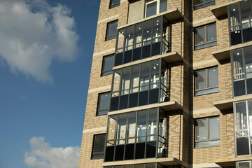 New building. Construction in city. Balconies and windows in house.