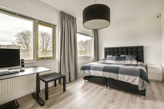 Modern bedroom interior with bed and computer table