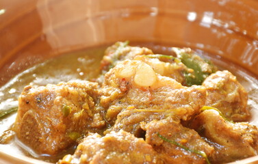 spicy fried pork bone with curry and basil leaf on bowl