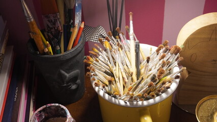 bucket of paintbrush  on a table