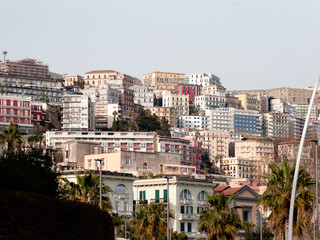 Fototapeta na wymiar Exterior buildings architecture on the Via Caracciolo ( Lungomare di Napoli a Mergellina) promenade at the Mediterranean sea shore in Naples, Italy