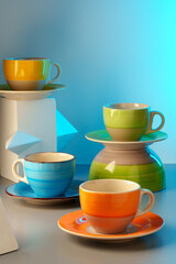 Colorful clay ceramic cups on gray background