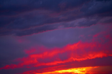 Fiery summer sunset landscape. Orange sun and dark blue sky