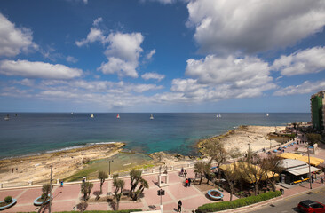 Fototapeta na wymiar panorama view of promenade and bay in Sliema, Malta. sailingboats on the sea. summer holiday view