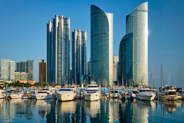 Obraz na płótnie Canvas Busan marina with yachts, Marina city skyscrapers with reflection, South Korea