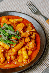 Dakgalbi, korean style Spicy Stir-fried Chicken with rice cake, Chicken pieces marinated in a gochujang, and stir-fried in a flat grill pan with cabbage, sweet potato, carrots, and tteok (rice cakes).