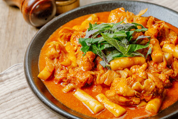 Dakgalbi, korean style Spicy Stir-fried Chicken with rice cake, Chicken pieces marinated in a gochujang, and stir-fried in a flat grill pan with cabbage, sweet potato, carrots, and tteok (rice cakes).