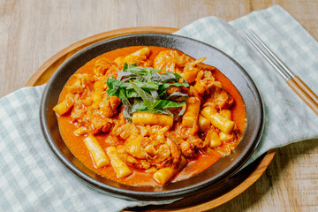 Dakgalbi, korean style Spicy Stir-fried Chicken with rice cake, Chicken pieces marinated in a gochujang, and stir-fried in a flat grill pan with cabbage, sweet potato, carrots, and tteok (rice cakes).