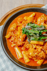 Dakgalbi, korean style Spicy Stir-fried Chicken with rice cake, Chicken pieces marinated in a gochujang, and stir-fried in a flat grill pan with cabbage, sweet potato, carrots, and tteok (rice cakes).