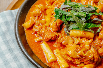 Dakgalbi, korean style Spicy Stir-fried Chicken with rice cake, Chicken pieces marinated in a gochujang, and stir-fried in a flat grill pan with cabbage, sweet potato, carrots, and tteok (rice cakes).