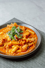 Dakgalbi, korean style Spicy Stir-fried Chicken with rice cake, Chicken pieces marinated in a gochujang, and stir-fried in a flat grill pan with cabbage, sweet potato, carrots, and tteok (rice cakes).