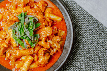 Dakgalbi, korean style Spicy Stir-fried Chicken with rice cake, Chicken pieces marinated in a gochujang, and stir-fried in a flat grill pan with cabbage, sweet potato, carrots, and tteok (rice cakes).