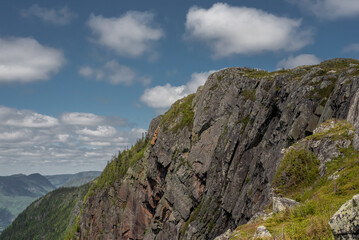 Fototapeta na wymiar Landscape in the mountains of Acropole des Draveurs, Quebec, Canada, with rocky cliff and blue sky with coulds