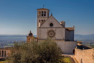 Fototapeta na wymiar Famous Basilica of St. Francis of Assisi (Basilica Papale di San Francesco) at day in Assisi, Umbria, Italy. Discover the beauty of historic Italian cities