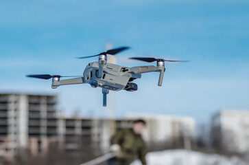 Obraz na płótnie Canvas Drone quadcopter against a blue sky. Air shooting, aerial reconnaissance