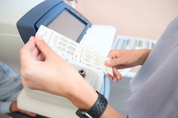 Female holding the prescription in the ophthalmology clinic