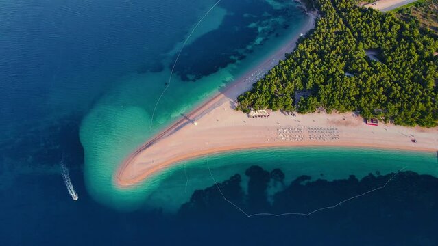 Aerial view of Zlatni Rat beach in Adriatic sea on Brac island, Dalmatia, Croatia. 4k drone video. Summer vacation resort