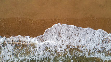 Top down view landscape scene of waves crashing on empty tropical beach