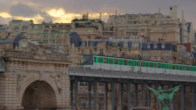 The movement of the subway train in the city center. The green train is moving along the rails. Public transport of the modern city. Moving people around Paris