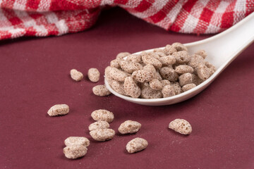 Roasted Crunchy Jowar and ragi - Indian Dietary Supplement, served in a bowl over moody background, selective focus.