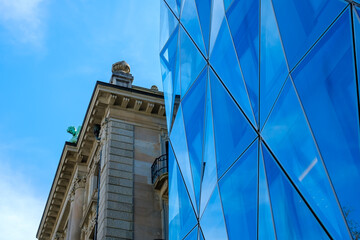 an old office building next to a new office building in Zurich