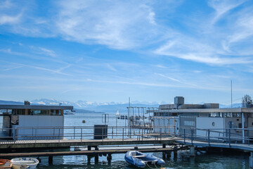 Zurich lake from Mythenquai near to enge. the sky is blue and the alps can be seen in the back.