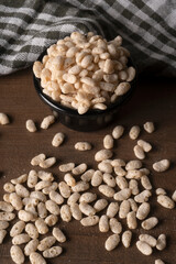 Roasted Crunchy Jowar and ragi - Indian Dietary Supplement, served in a bowl over moody background, selective focus.