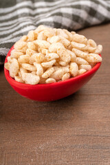 Roasted Crunchy Jowar and ragi - Indian Dietary Supplement, served in a bowl over moody background, selective focus.