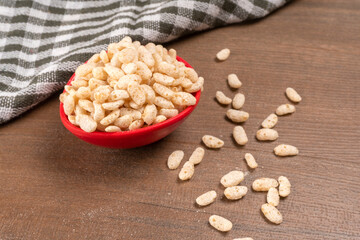 Roasted Crunchy Jowar and ragi - Indian Dietary Supplement, served in a bowl over moody background, selective focus.