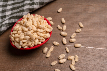 Roasted Crunchy Jowar and ragi - Indian Dietary Supplement, served in a bowl over moody background, selective focus.