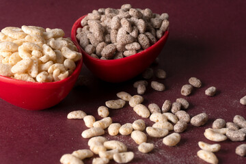 Roasted Crunchy Jowar and ragi - Indian Dietary Supplement, served in a bowl over moody background, selective focus.