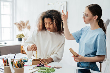 Fototapeta premium Accessories Designer: Design fashion accessories, jewelry, handbags, scarves, hats. Fashion designers, female small local business owner at work in fashion studio