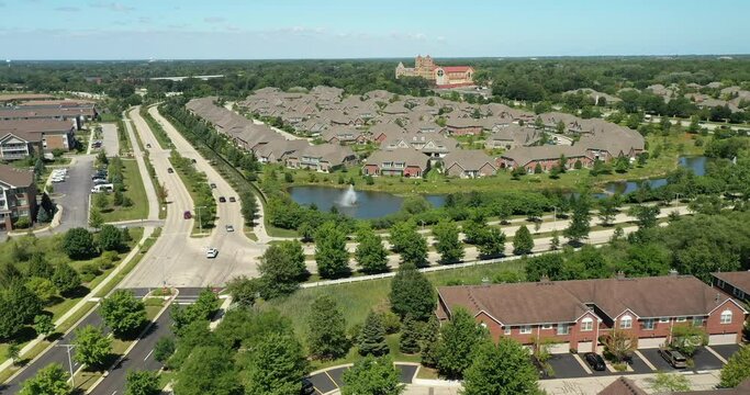 Aerial view of a townhouse complex in a semi-circular Chicago suburban neighborhood in summer.