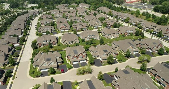 Aerial view of a townhouse complex in a semi-circular Chicago suburban neighborhood in summer.