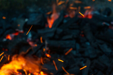 Coals with sparks in a huge old metal grill