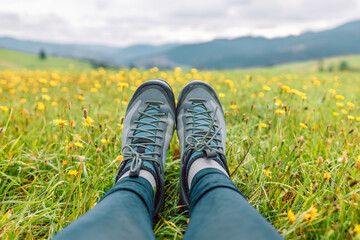 Girl hiking boots having fun and enjoying wonderful breathtaking mountain view. Freedom concept....