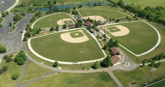 Aerial view of a suburban high school baseball complex with four ballfields.