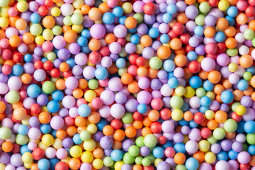 Colorful texture. Vibrant color children play balls. Small grainy toy. Funny background. Styrofoam vibrant color. Decorative pattern. Decoupage background. Creative child play. Bubble background.