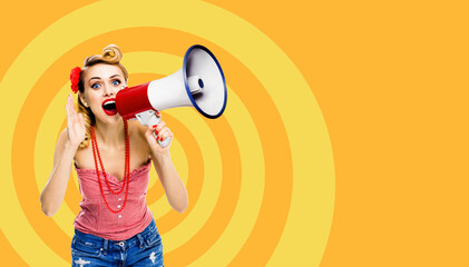 Happy excited woman hold mega phone loudspeaker and shout something. Blond girl in pin up style with wide open mouth, over orange yellow spiral background. Female model in retro vintage ad concept