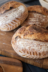 Artisan Batard Sourdough healthy Bread with leaf scoring. Open crumb high hydration Sourdough bread set on white table. - 587000137