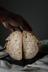 Artisan Batard Sourdough healthy Bread. Open crumb high hydration Sourdough french country bread set on dark background. - 587000155